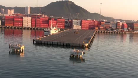 Aerial-view-departing-a-commercial-shipping-pier-on-a-calm-day