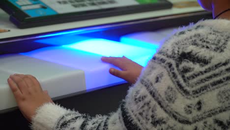 An-unidentified-child-plays-on-a-keyboard-at-an-arcade-game