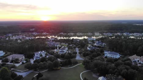 Aerial-View-of-North-Florida-Neighborhood-Bordering-Dense-Forestry-During-Sunset