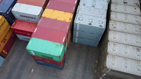 Aerial-tilt-down-shot-of-cargo-container-in-harbor-from-all-over-the-world-in-shipyard