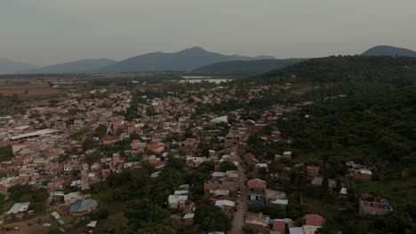 Drone-shot-in-Mexico-Michoacan,-old-town-and-old-houses,-green-forest-background