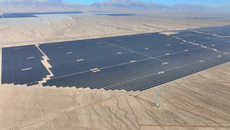 Various-different-solar-farms-in-arid-sunny-desert-area-panning-aerial-view-for-sustainable-renewable-energy-generation