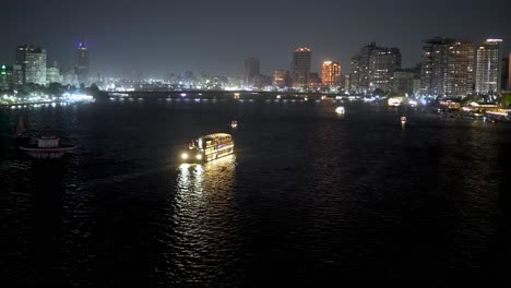 Dinner-cruise-boats-on-the-Nile-River-in-Cairo,-Egypt-at-nighttime---time-lapse