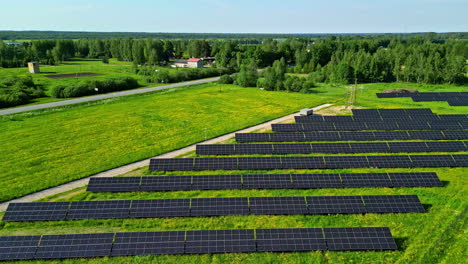Solar-panel-in-green-summer-field-generating-clean-energy---aerial