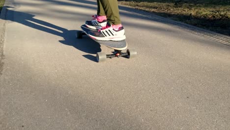 Low-angle-of-skateboarder-riding-on-sidewalk,-alternative-transportation