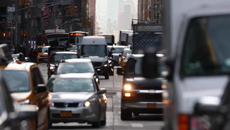 Slow-motion-shot-of-large-street-in-NYC-packed-with-cars,-taxi-and-trucks