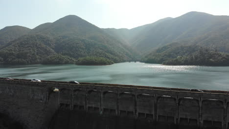 Aerial-drone-shot-of-Tai-Tam-Tuk-Reservoir-Dam-on-a-sunny-day