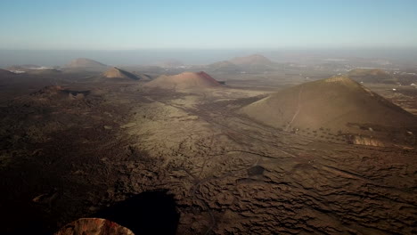 Flying-over-crater-of-volcano,-Lanzarote,-Spain,-Canary-Islands
