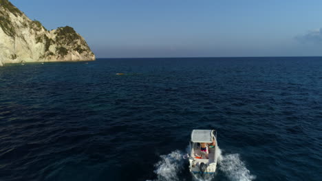Aerial-view-following-boat-excursion-sightseeing-tour-off-Zakynthos-Greek-island-coastline-travel-destination