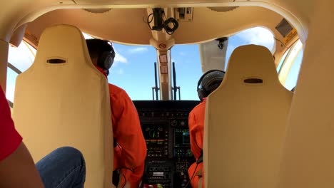 Two-helicopter-pilot-preparing-and-checking-the-controls-before-taking-with-passenger-onboard
