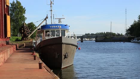 Wide-shot-of-small-ship-in-peaceful-seaport-in-Finland