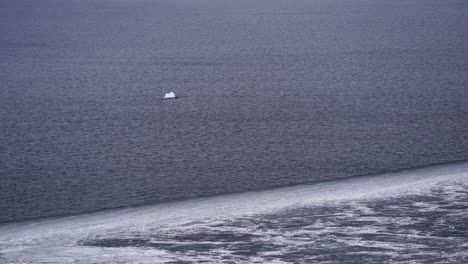 Lone-iceberg-floating-off-the-coast,-global-warming,-climate-change