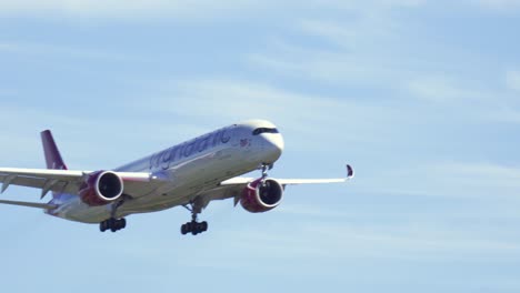 Close-up-sot-of-Virgin-Atlantic-Airbus-A350-comes-in-to-land-at-London-Heathrow-Airport,-Hand-held-shot