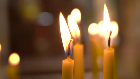 Two-Candles-Slowly-Burning-Inside-of-Madaba-St-George's-Greek-Orthodox-Church,-100-Frames-Per-Second