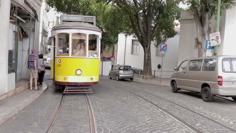 Electrico-tram-cruising-trough-the-streets-of-Lisbon-front-tracking-shot