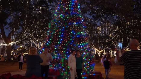 People-take-pictures-and-selfies-in-front-Christmas-tree-in-downtown-Saint-Augustine-at-night