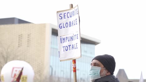 Man-is-holding-a-poster-which-show-that-he-is-against-proposed-new-law-about-global-security