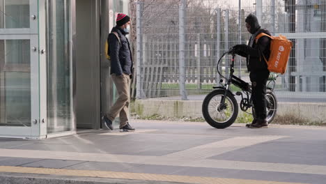 People-Waiting-a-Train-at-Station