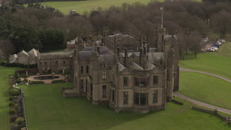 aerial-drone-shot-of-a-gothic-mansion-castle-in-the-rich-countryside