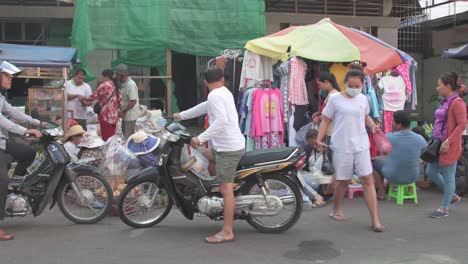 Personas-En-Camboya-Viajando-En-Motocicletas-Por-La-Calle-Bazar.