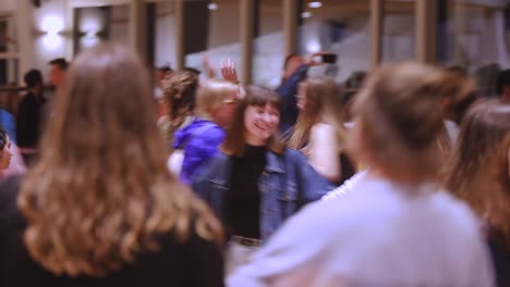 Crowd-Of-People-Joyfully-Dancing-At-The-Conference-Hall-Of-Waldorf-School-In-Netherlands---medium-shot