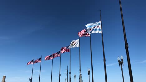 Flags-of-Chicago,-Illinois-and-the-United-States-of-America-waving-in-the-navy-pier-of-Chicago