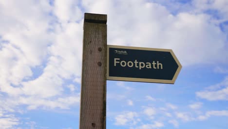 Close-up-panning-shot-to-reveal-footpath-sign