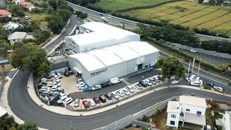 Aerial-drone-flight-over-a-Renault-car-dealership-and-repair-centre-in-Saint-Pierre,-Reunion-Island