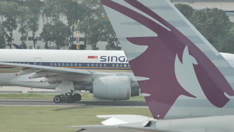 Qatar-airplane-on-tarmac-passing-plane-from-behind