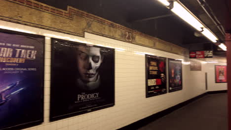 Traditional-print-billboard-ads-on-the-23-street-subway-platform