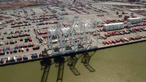 Aerial-view-of-Port-of-Oakland-Cranes-of-green-Bay-Area-water