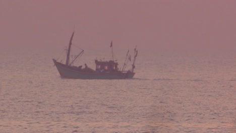 Fishing-boat-in-sea-at-sunset