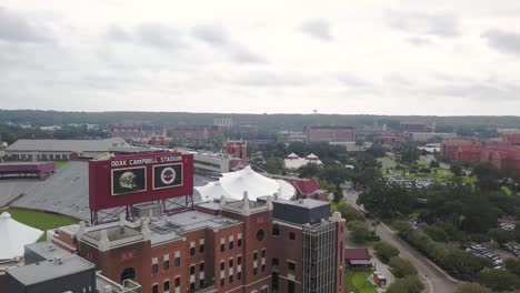 Flying-around-Doak-Campbell-stadium-to-reveal-Florida-State-campus-in-background,-Tallahassee,-aerial