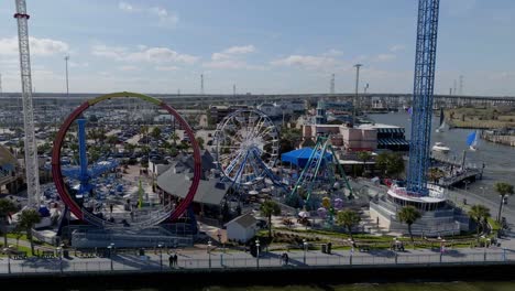 Aerial-view-around-rides-at-the-Kemah-Boardwalk,-in-sunny-Texas,-USA---orbit,-drone-shot