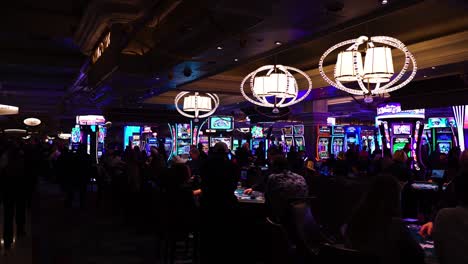 Interio-of-Bellagio-Casino,-People-Gambling-on-Blackjack-Tables-and-Slot-Machines,-Las-Vegas-USA