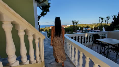 Woman-on-Balcony-Overlooking-Scenic-Resort-in-Slow-Motion-follow-shot