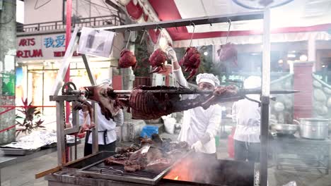 The-cooking-of-a-whole-animal-showcased-on-the-street-during-a-festival