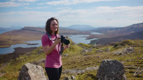 Caucasian-Woman-Takes-Pictures-From-Scenic-Viewpoint-at-Isle-of-Skye