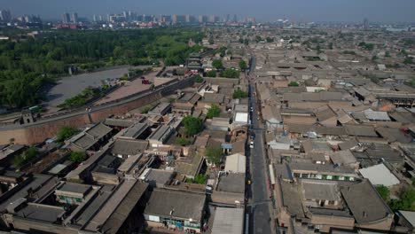 Pingyao-Ancient-Town's-traditional-architecture-and-city-wall-seen-from-above,-orbit