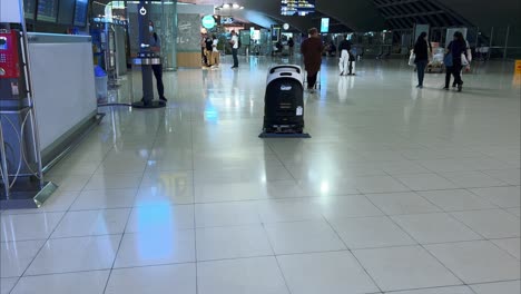 Robot-vacuum-automatically-moving-around-the-airport-and-performing-cleaning-work