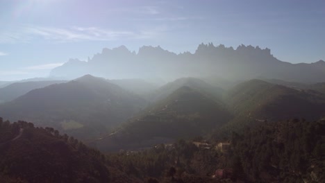 Mountainous-landscape-in-the-Marganell-region-of-Barcelona-with-morning-mist-and-distant-peaks
