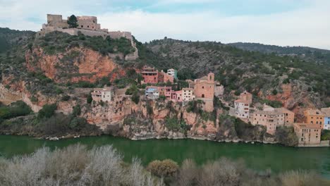 Picturesque-view-of-Miravet-town-nestled-on-a-hill-by-the-river-in-Tarragona-Spain