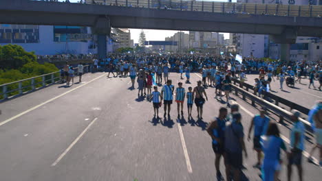 Flyover-shot-of-25-de-Mayo-highway-crowded-with-Argentinian-football-soccer-fans,-during-FIFA-World-Cup-celebration,-in-Argentina-Buenos-Aires