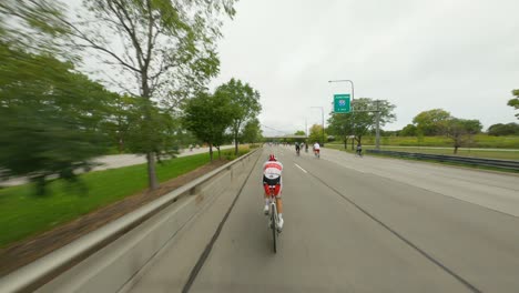 Chicago-cyclists-riding-northbound-on-DuSable-Lake-Shore-Drive-during-Bike-the-Drive-2022-red-triathlon-triathlete-time-trial-bike-south-side-pedestrian-bridge