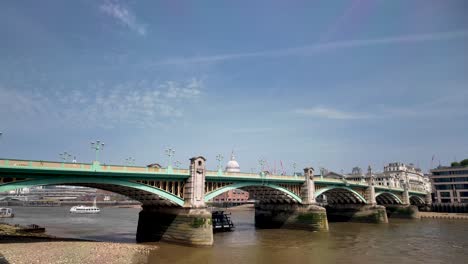 River-Boat-Cruising-On-River-Thames,-Passing-Through-Arch-Of-Southwark-Bridge-In-London,-UK