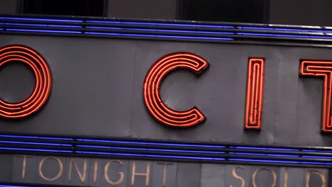 Slow-motion-left-to-right-movement-of-Radio-City-Music-Hall-horizontal-sign-on-sixth-avenue,-Midtown-Manhattan,-New-York-City