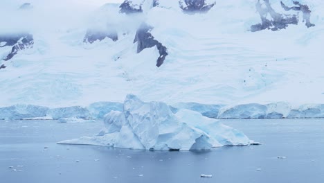 Antarctica-Winter-Iceberg-Landscape-on-Coast-in-Cold-Blue-Antarctic-Peninsula-Scenery-with-Snowy-Snow,-Ice-and-Glacier-in-Dramatic-Beautiful-Coastal-Scene-with-Ocean-Sea-Water