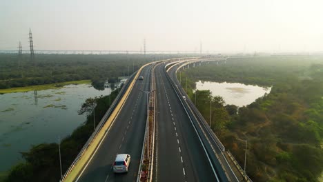 Hazy-day-on-India-highway-to-Mumbai,-city-smog-in-nature-infrastructure