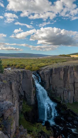 Vertical-4k-Timelapse,-Clouds-Moving-Above-Waterfall,-Cliffs-and-Sunny-Landscape