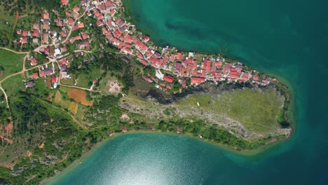 Picturesque-Lakeside-Village-of-Lin-with-Emerald-Waters-Seen-from-the-Air:-The-Beautiful-Rocky-Peninsula-Edge-of-Lake-in-Albania